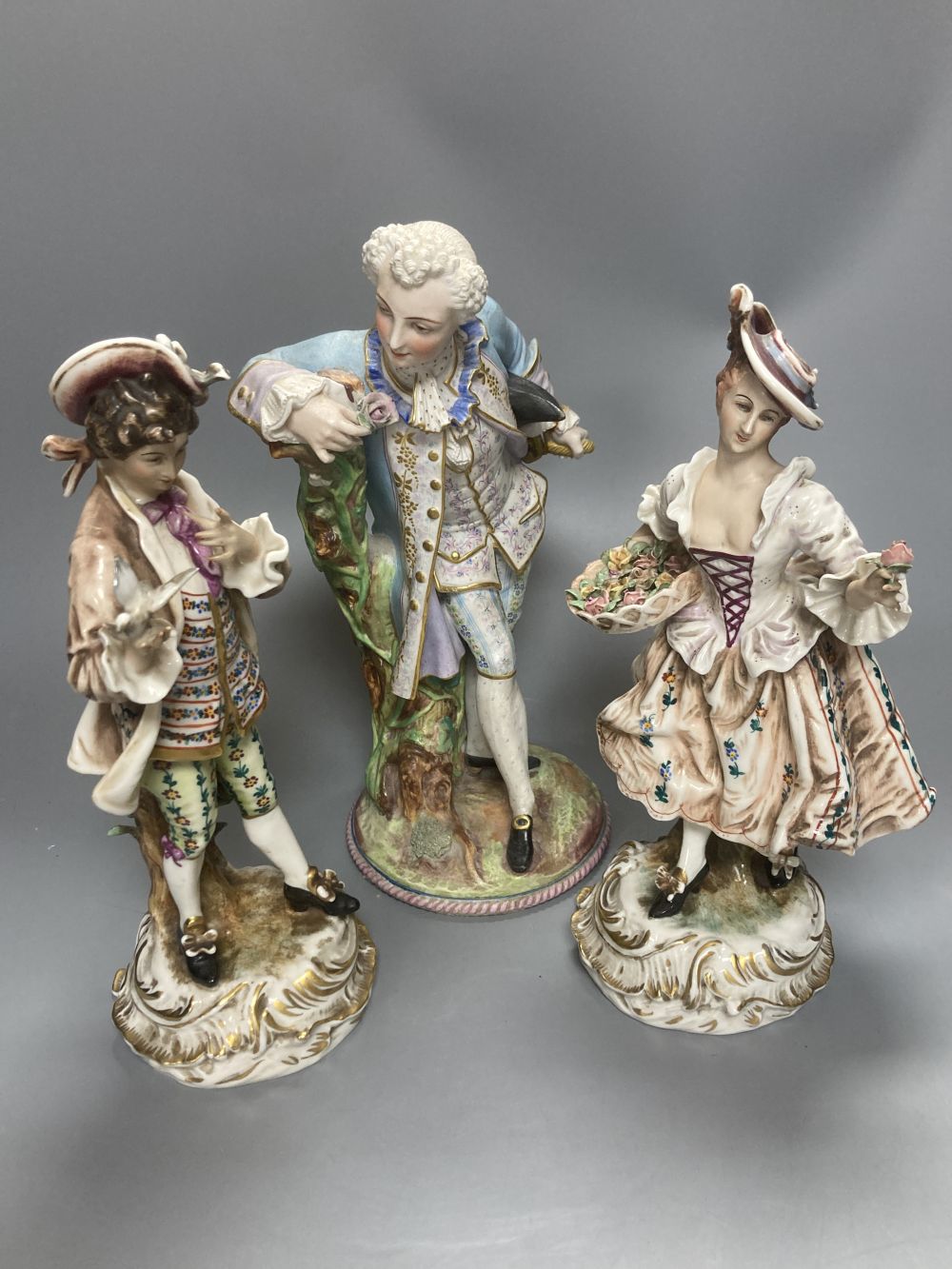 A pair of Wessel Frankenthal figures, 26cm, and a French bisque gallant, 29cm